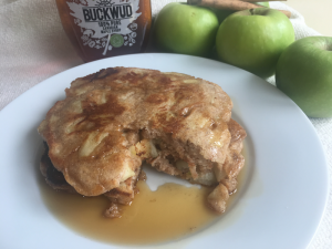 spiced apple pancakes with syrup and bite