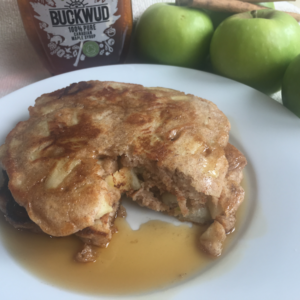 spiced apple pancakes with syrup and bite